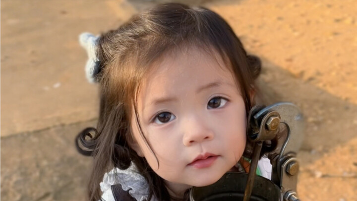 The charm of a rural hand pump well—no baby could possibly resist it, right?