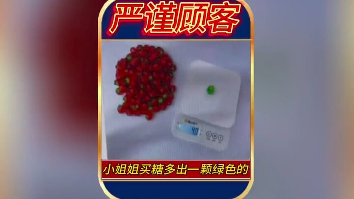 The girl bought some candy and got an extra green one.