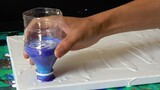 Use a mineral water bottle as a funnel to do fluid painting
