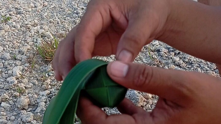 making tubol ball. using coconut leaves.