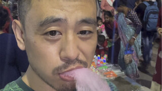 Eating cotton candy at Indian night market