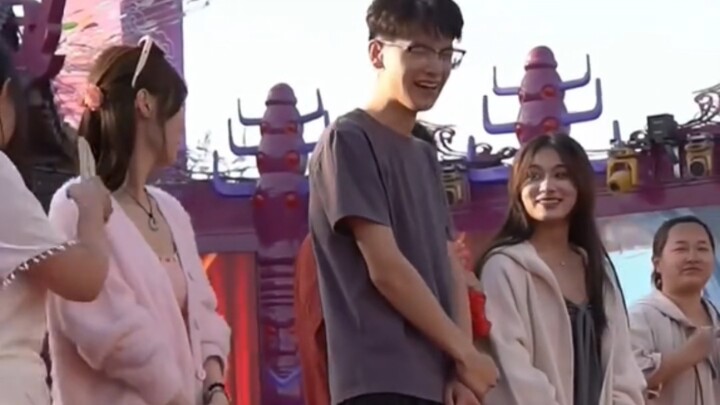 At a dating show, a 24-year-old man from Shanxi is joined on stage by six women.