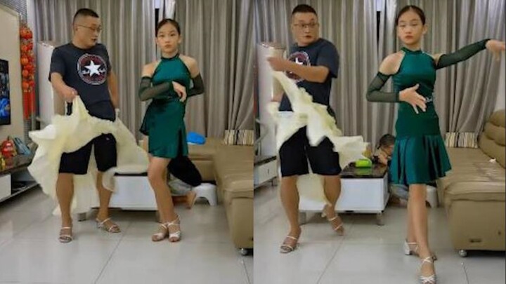 Dad practices Latin dance with his daughter, wildly swinging the "skirt" in an awkward dance that's 