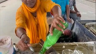 A special iced drink on the streets of India. The lady’s hands are fast and her technique is cool. D