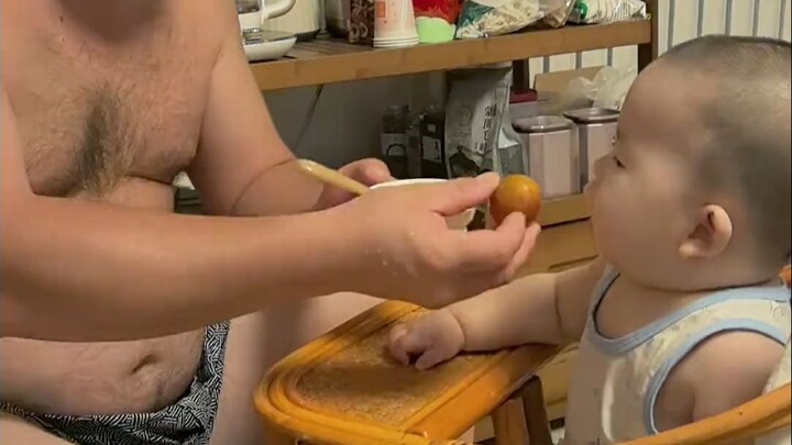 Dad feeds the kid—just one plum, and it fooled us into thinking we had three meals a day!