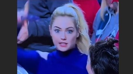 Find a spectator in the stadium who looks like the person in the picture.