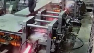 Trong xưởng sản xuất cốt thép, thanh cốt thép đỏ rực đột nhiên trượt ra, lao thẳng về phía công nhân
