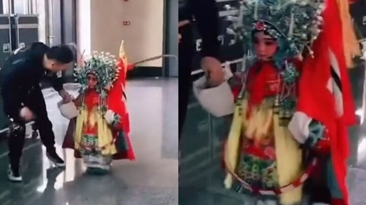 The four-year-old apprentice performed in costume, swaying steadily with each step. The master bent 