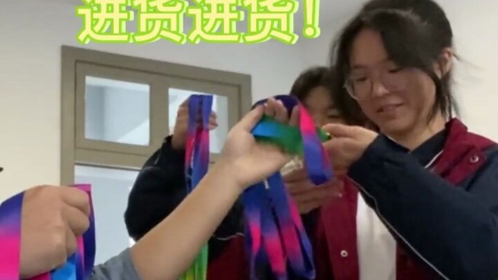 The class won first place in the sports meet, and the head teacher proudly showed off their medals b