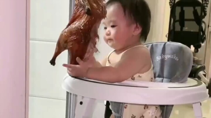 This little human baby, who’s quick-eyed, quick-handed, and even quicker-tongued, must be starving!