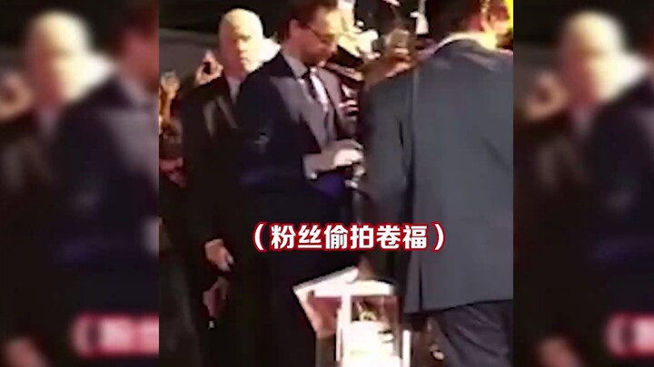 Siêu ấm lòng! Tom Hiddleston giúp fan lén chụp ảnh “Cuộn Phúc”, dáng vẻ lén lút sợ bị phát hiện đáng