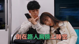 A girl fell asleep on a stranger's shoulder, and the guy gently woke her up by stroking her head whe