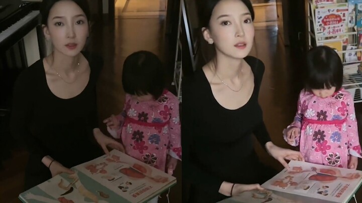 A man shares his model wife’s daily life with their child, dressed in all black with a poised and el