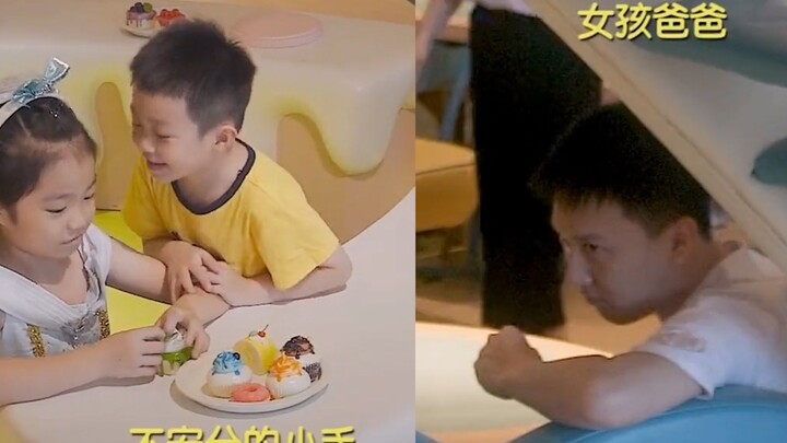 A boy eagerly strikes up a conversation with a girl. His dad beams with pride, eyes squinted in a go