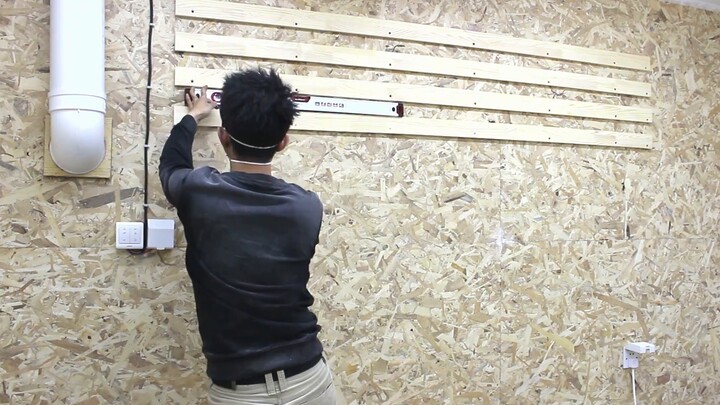 Power tool storage wall in wood workshop