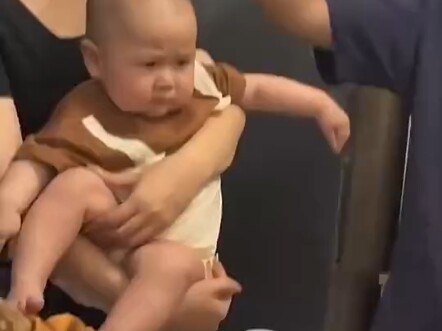 This thing looks like a “soul extractor,” and the baby’s expression is priceless.
