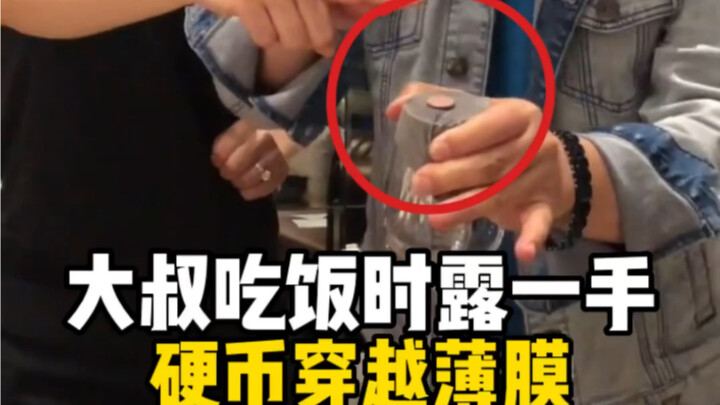 An older gentleman performs a coin-through-plastic trick during dinner—real masters are out there!