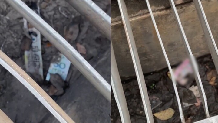 A woman passing by a manhole spotted 50 yuan. She used an umbrella to flip it open, only to blush at