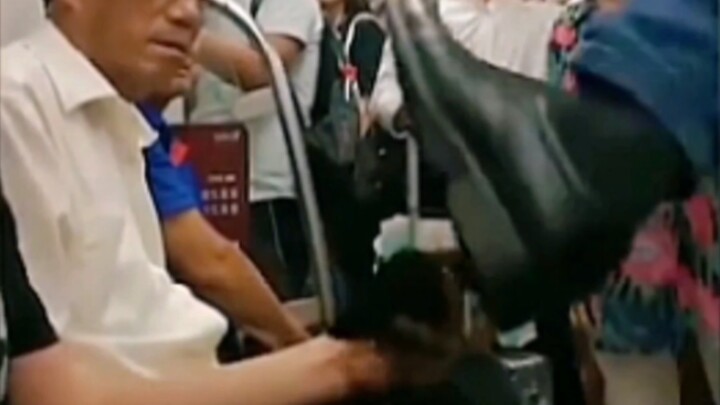 Young man refuses to give up his seat for a man on the subway and gets kicked hard; the man then lec