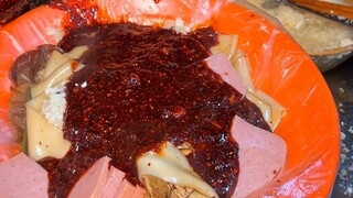 Spicy hot pot in a quiet alley of Lanzhou, topped with Gansu's signature wide rice noodles—absolutel