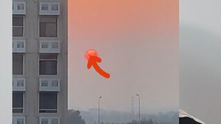 What is that dark shadow on the Sun? It can't possibly be a feature on the Sun's surface—if it were,