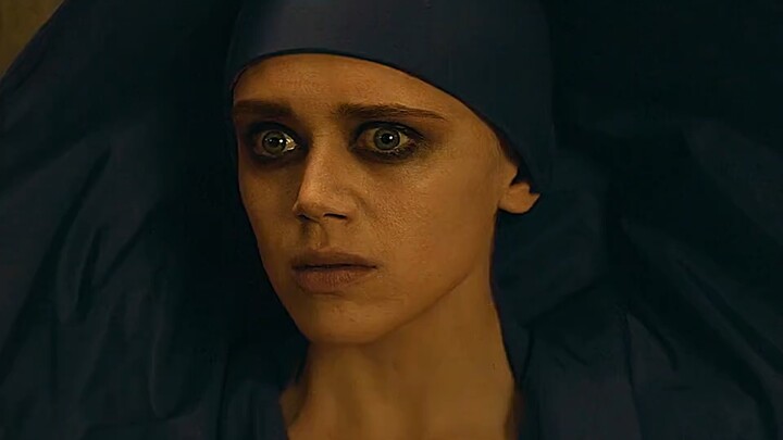 A bee flies in, leaving the witch flustered.