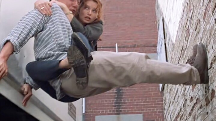 Uncle Long holds the girl, suspended in mid-air