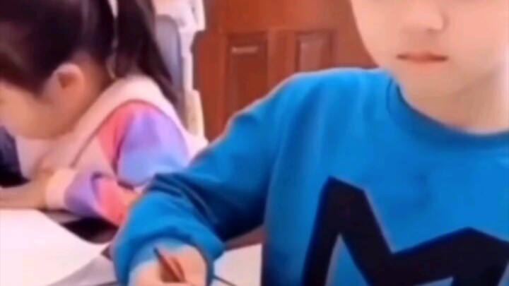 Brother gets scolded for doing homework, and little sister delivers a perfect comeback to “save” him