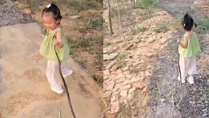 2.5-year-old cutie treats a dried snake like a toy, keeps a totally chill expression when asked why—