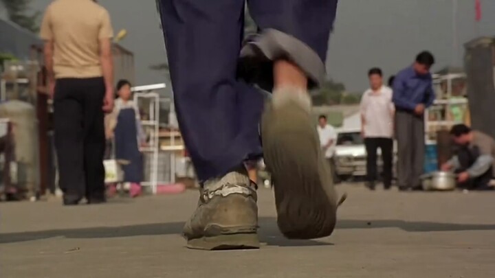 How does Stephen Chow use a close-up of a shoe to cleverly transition between scenes to differentiat