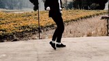 Young man performs Michael Jackson's classic dance Dangerous on a country road