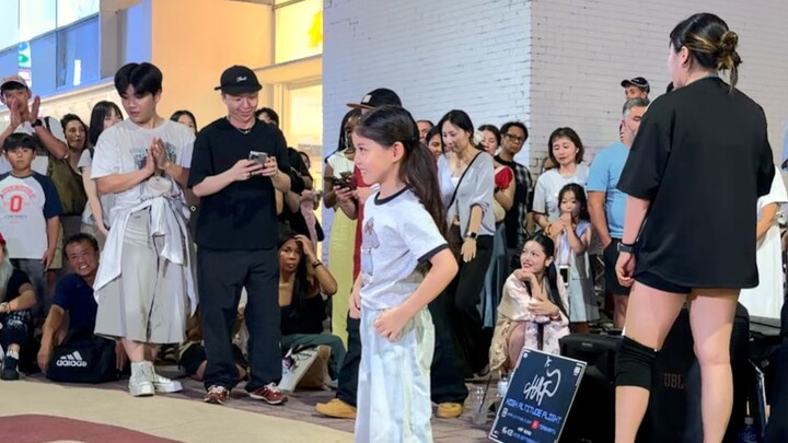 Blowing the crowd away! A young Chinese dancer drops into the streets of Seoul, and her adorable pop