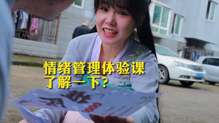 The young girl handing out flyers, carrying a large basket on her back.