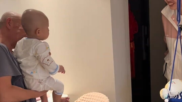An eight-month-old baby reunites with his mom, who’s been studying abroad, two months later. The who