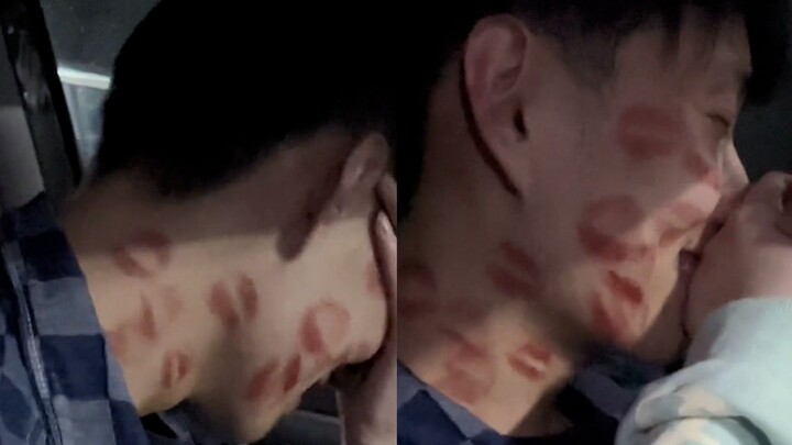 Guy gets smothered with lipstick kisses by his girlfriend, instantly turning into a blushing, fluste