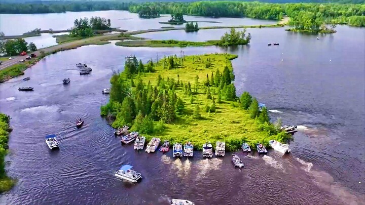 Over a dozen small boats are pushing the little island to move.