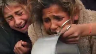Children scream as they line up at a charity kitchen in Gaza in search of a minor meal,