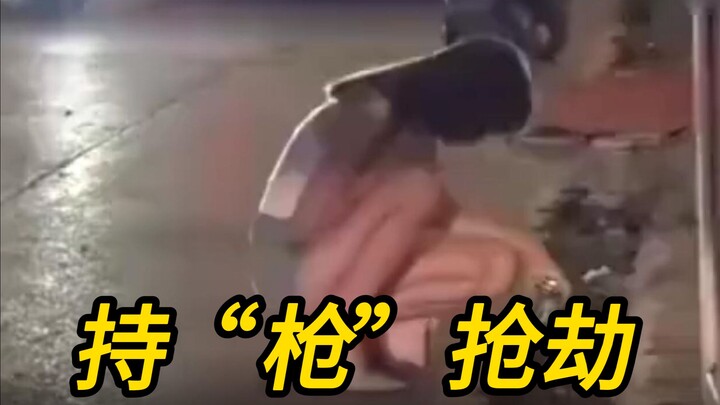 A blatant “gun”-wielding robbery leaves the beauty blushing.