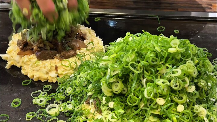 Drowned in a sea of scallions you can’t even see the batter, yet every bite bursts with flavor and a