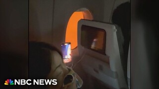 Video shows passengers stuck on burning plane in Japan