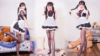 A girl dancing in cat ears and maid costume