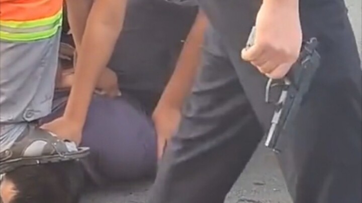 Man refuses to get out of his car after hitting someone and is subdued by police who draw their guns