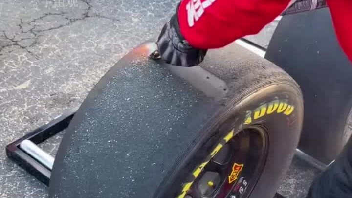 Why do race car tires spray flames and scrape off rubber?