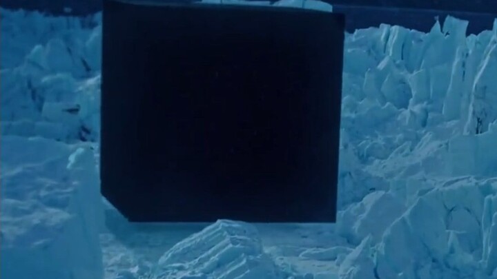 A massive black cube appears in a sinister form over Earth’s North Pole.