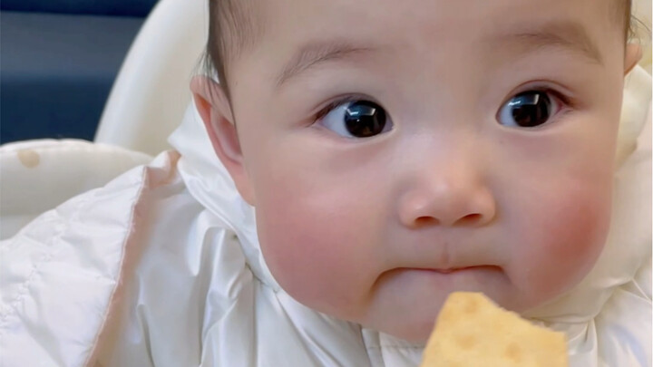 A human baby’s first time eating snacks…