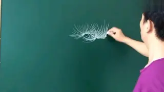 The art teacher draws a beautiful picture scroll with chalk.