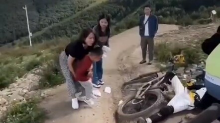 Ta Wu kid gets hit while walking on the mountain bike trail.