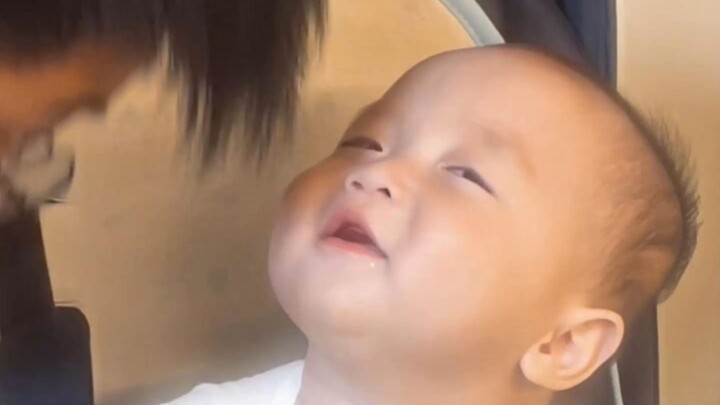 Baby is thoroughly enjoying the magical sensation of their hair—feels like it’s about to sweep their