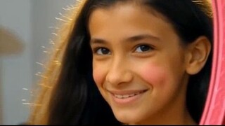 A girl gazes intently at her reflection in the mirror, contempl