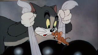 A little kitten playing bowling,